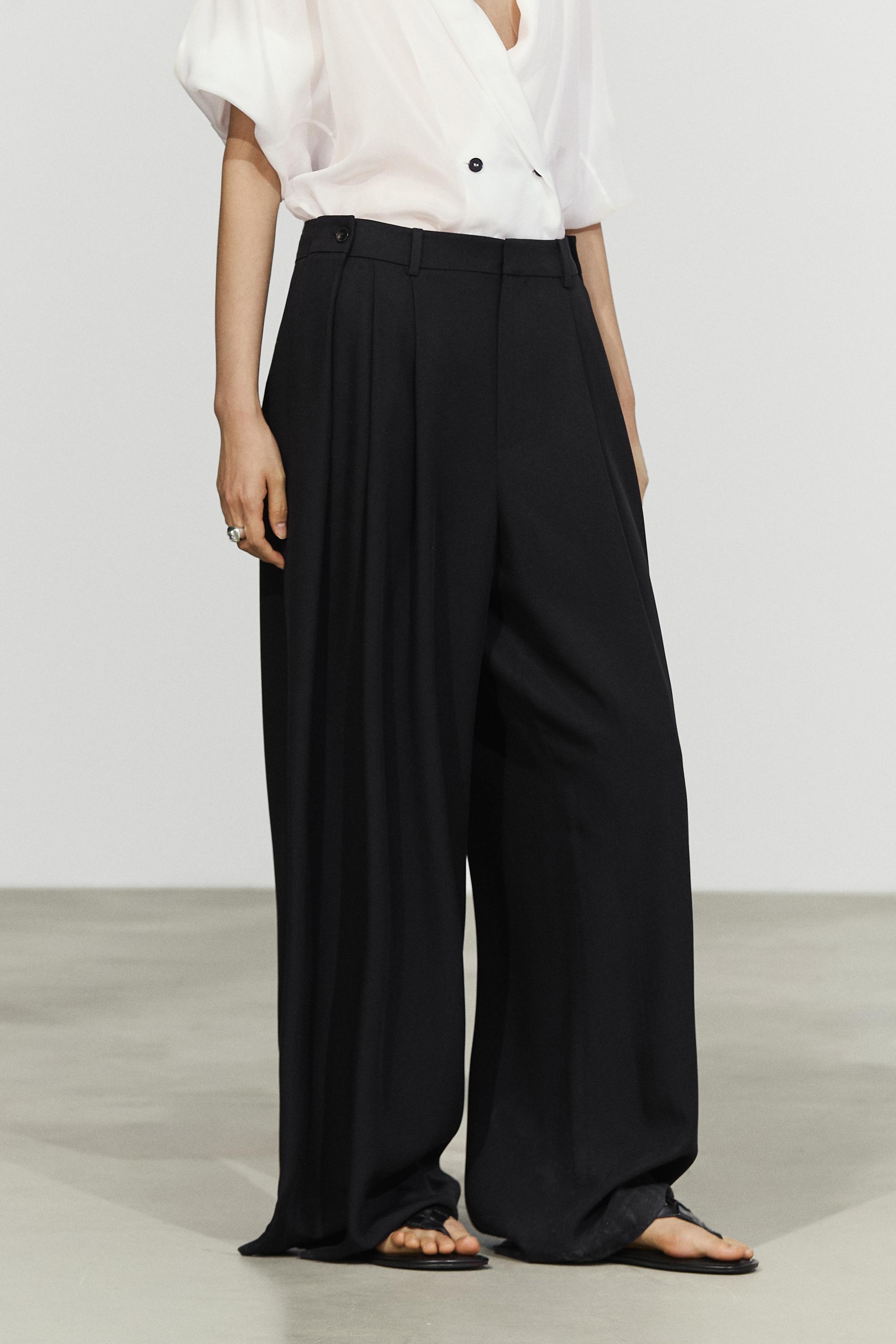 Flowing pleated pants with button detail Black