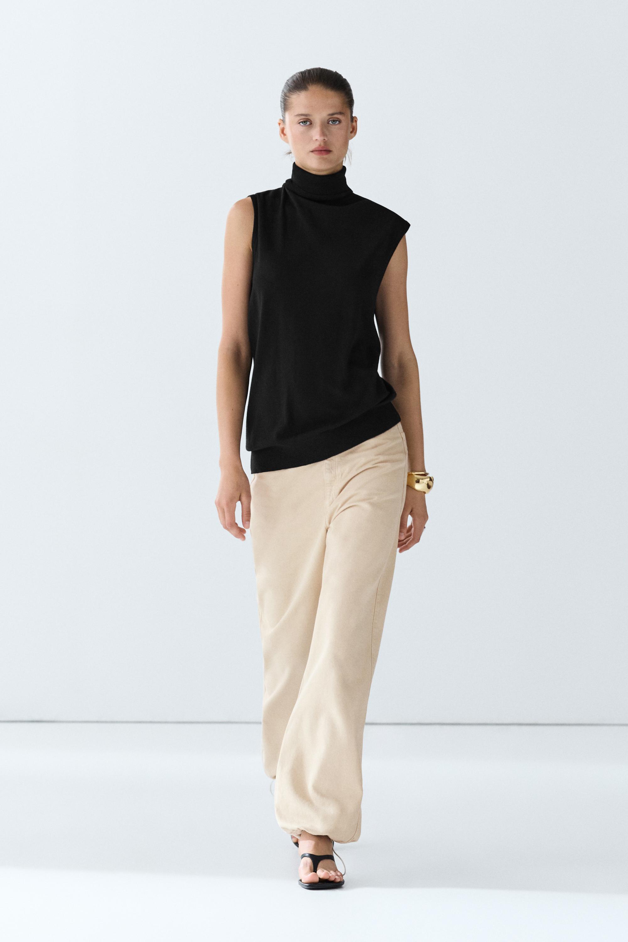Asymmetric hem turtleneck top Black