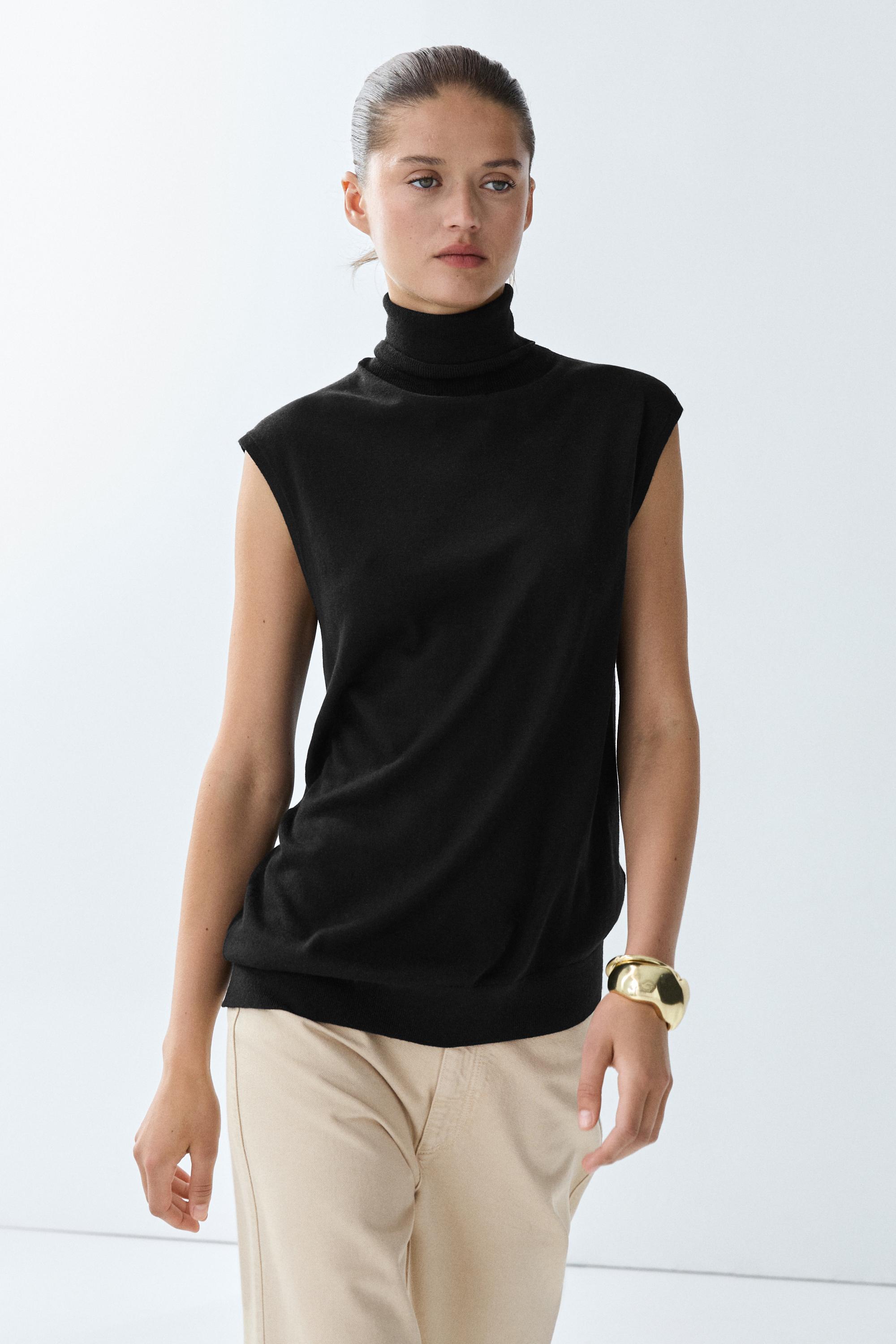 Asymmetric hem turtleneck top Black